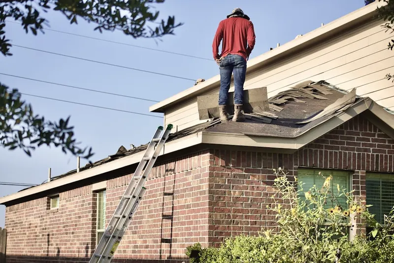Professional roofer working on a residential roof in Cloverleaf